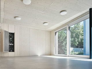 Der Ort nahm grossen Einfluss auf den Pavillon: Die Fassade spiegelt den Baumbestand der Umgebung wieder. Im Rücken der Kirche eröffnet er zusammen mit dem kleinen Park einen Ort der Stille.
